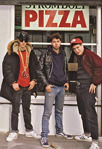 Beastie Boys posing in front of a pizza shop, wearing casual clothing.