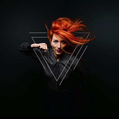 A woman with vibrant orange hair punches forward against a black background with triangles.
