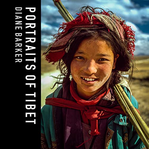 Close-up portrait of a smiling young Tibetan woman with a red hat.
