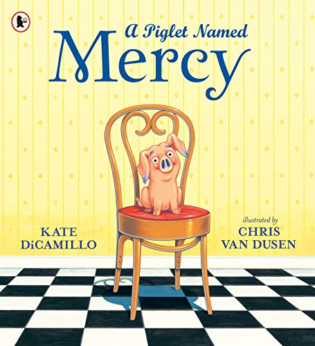 Pink piglet Mercy sits on a wooden chair with a checkered floor.
