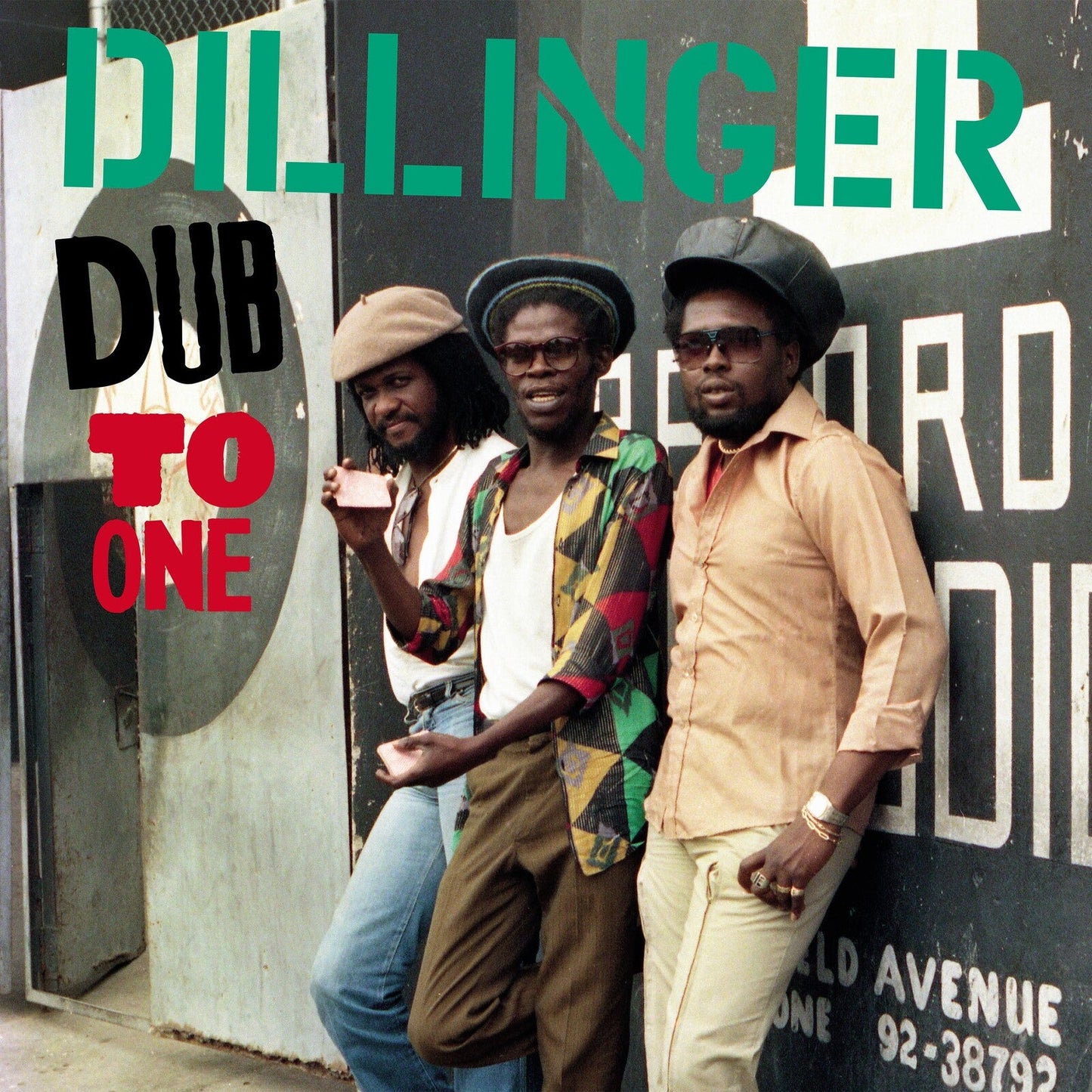 Dillinger album cover: three men with dreadlocks standing in front of graffiti.