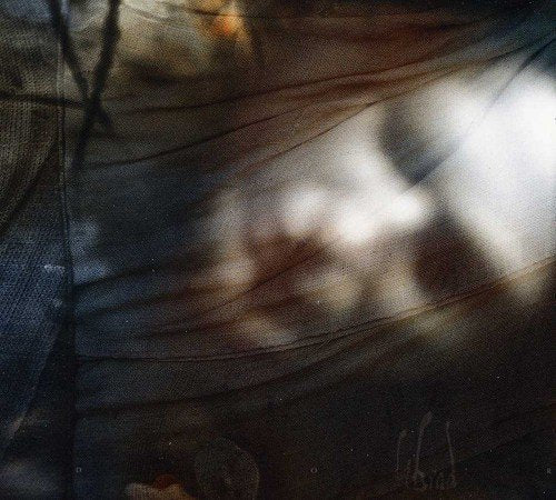 Abstract textured fabric in brown and grey tones with soft light and shadows.