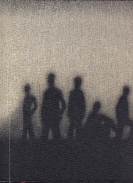 Book cover with blurred silhouettes of figures in a dark scene.