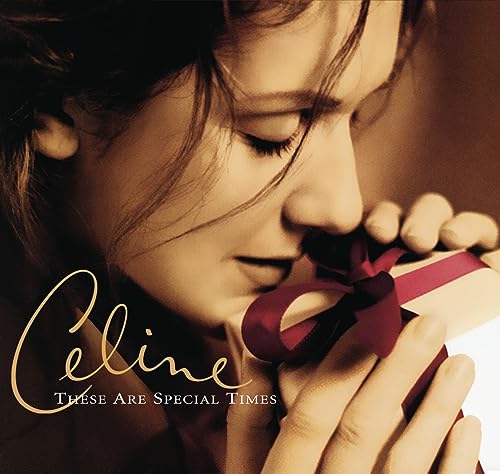 Celine Dion album cover, close-up of her holding a red ribboned gift.