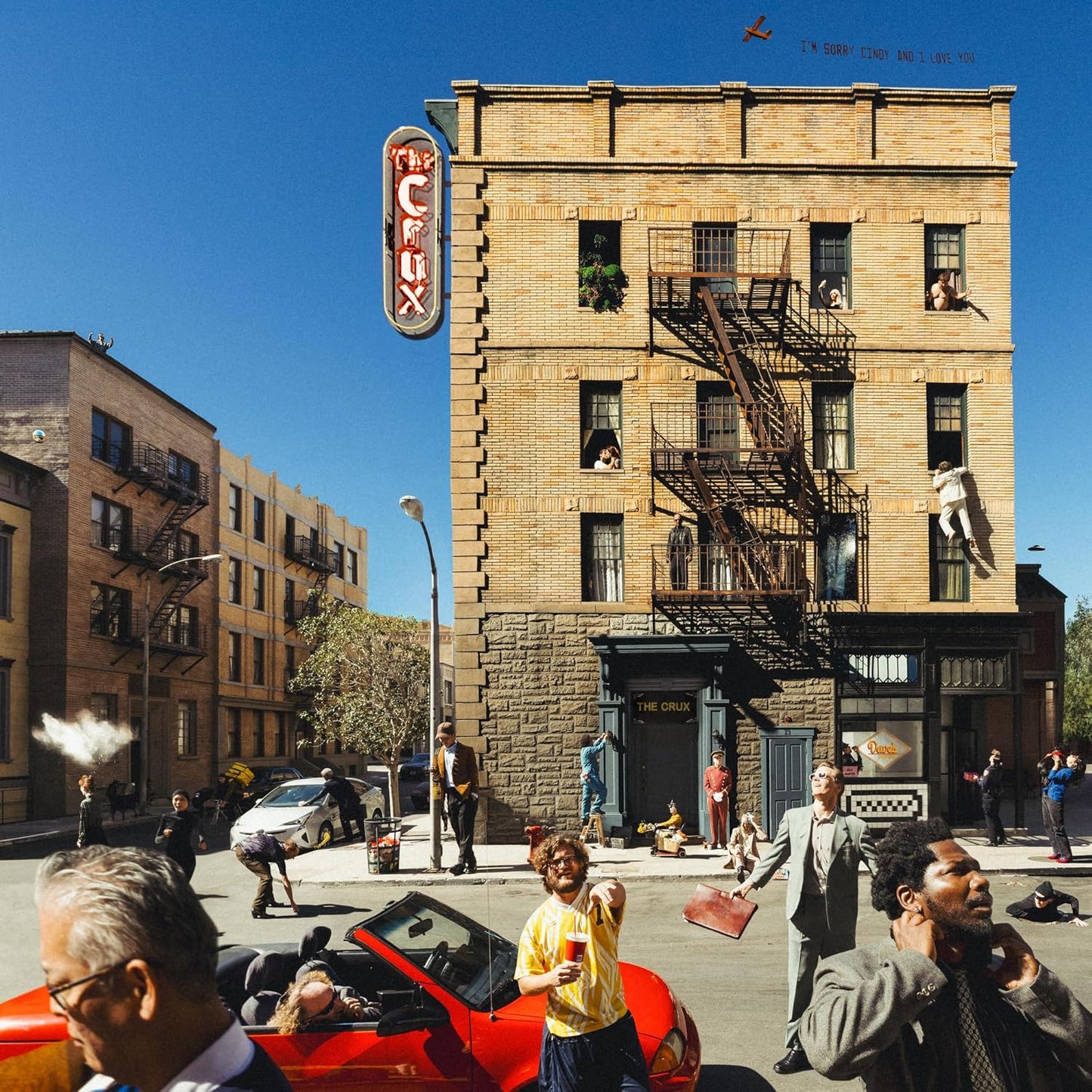 Album cover for Djo’s “The Crux” depicts a brick building and street scene.