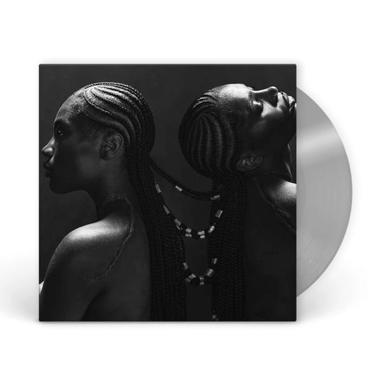 Black and white portrait of Doechii with braided hair, vinyl record beside.