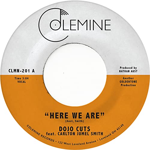 7-inch vinyl record label for Dojo Cuts’ “Here We Are” with gold text.