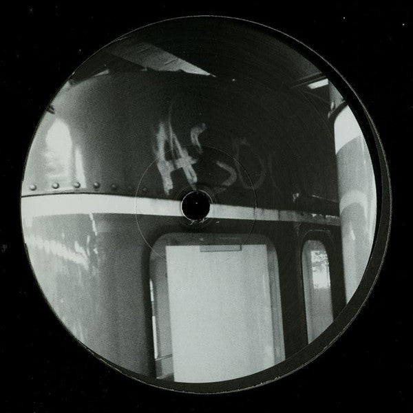 Black vinyl record with graffiti-style white lettering and a central hole.