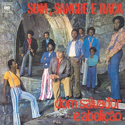 Album cover featuring a group of musicians posing in front of a cave.