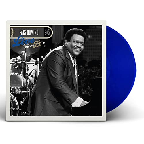 Fats Domino album cover and blue vinyl record shown at angle.