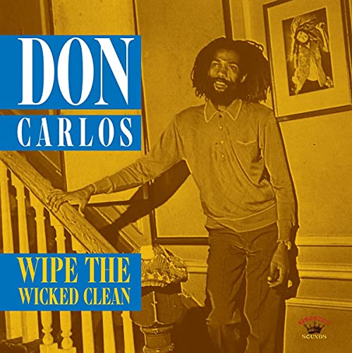 Don Carlos album cover: portrait of a reggae musician on stairs.