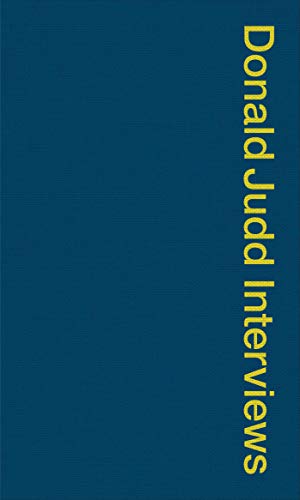 Book cover with a dark blue background and yellow vertical text reading Donald Judd Interviews.