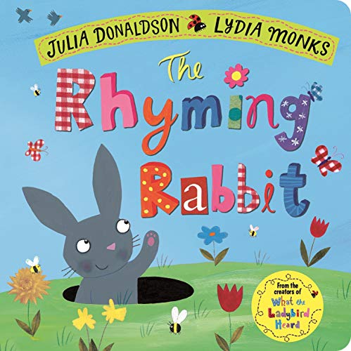 Book cover: gray rabbit peeking from a hole in a flower-filled field.