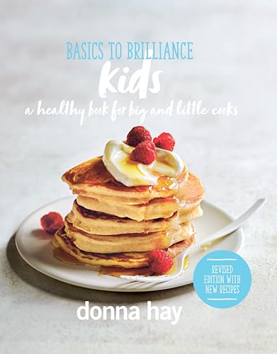 Cookbook cover with a stack of pancakes topped with raspberries and cream.