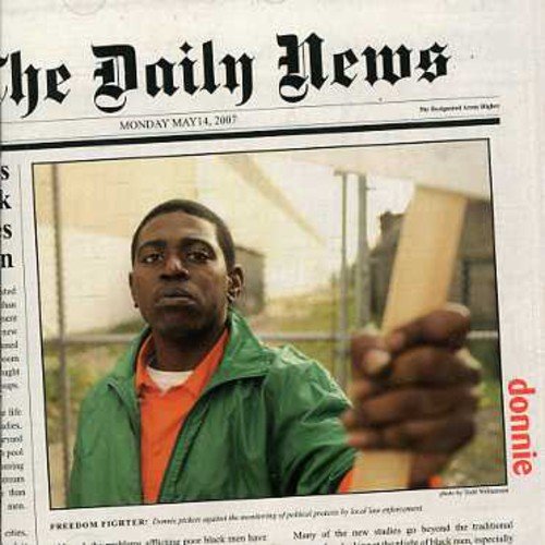 "Newspaper front page with a man holding a wooden plank, dated May 14, 2007."