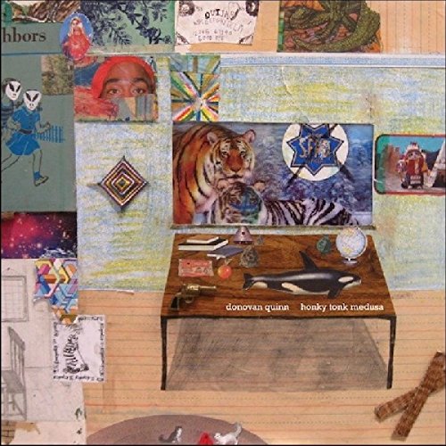 "Collage album cover with wooden table, tiger, and orca, surrounded by various images."
