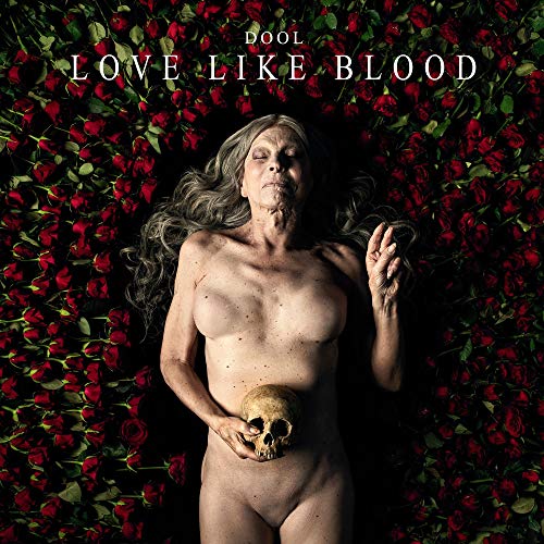 Album cover: woman with skull amidst a bed of red roses.