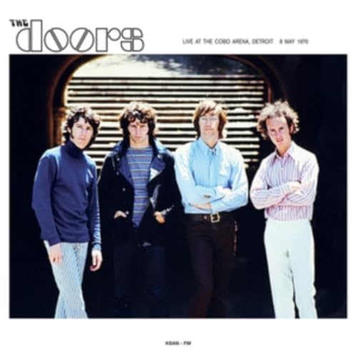 The four members of The Doors standing in front of an arched doorway.