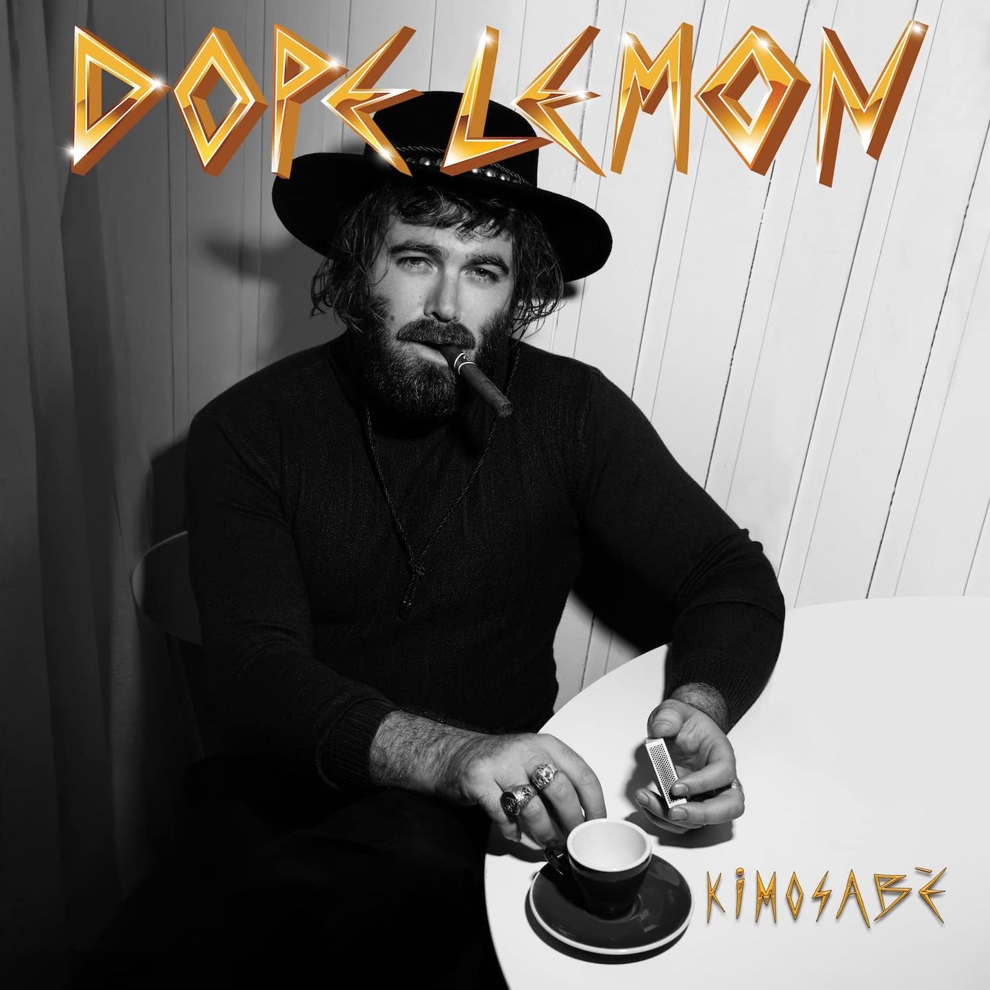 Black and white album cover featuring a man with a hat and cigar.