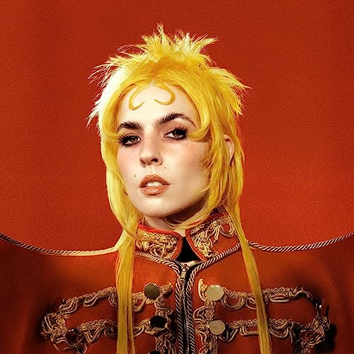 Dorian Electra portrait with spiky blonde hair and ornate jacket.
