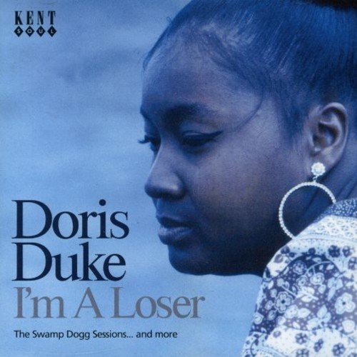 "Album cover featuring a blue-toned profile of a woman with large hoop earrings."