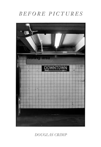 Black and white subway station interior with “Downtown” sign.