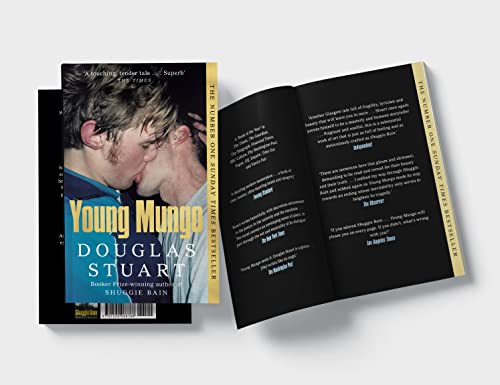 Book cover with two men kissing, open to text on black pages.