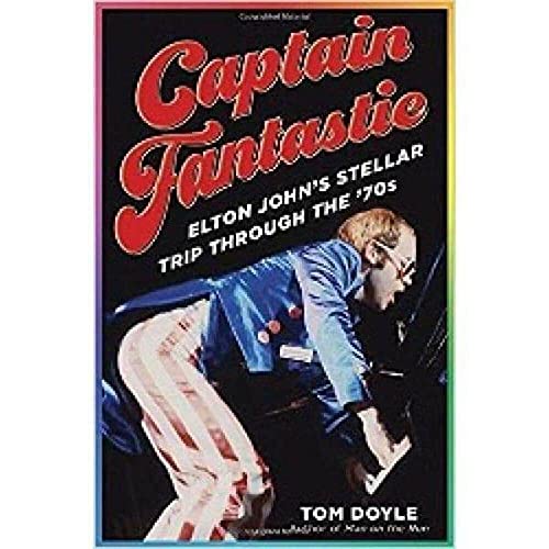 Book cover featuring Elton John playing piano in a blue suit.