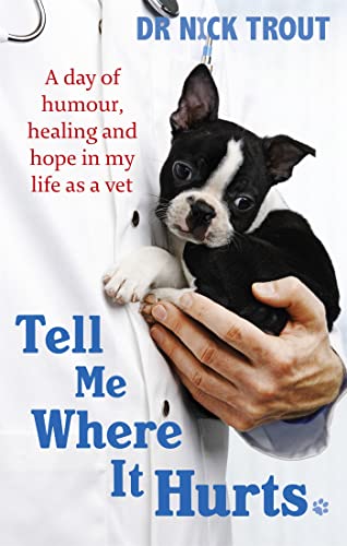 A veterinarian in a white coat holds a small Boston Terrier puppy.