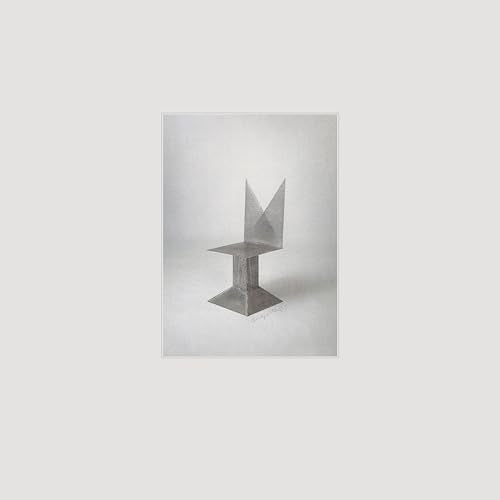 Black and white image of a geometric, angular sculpture on a light background.