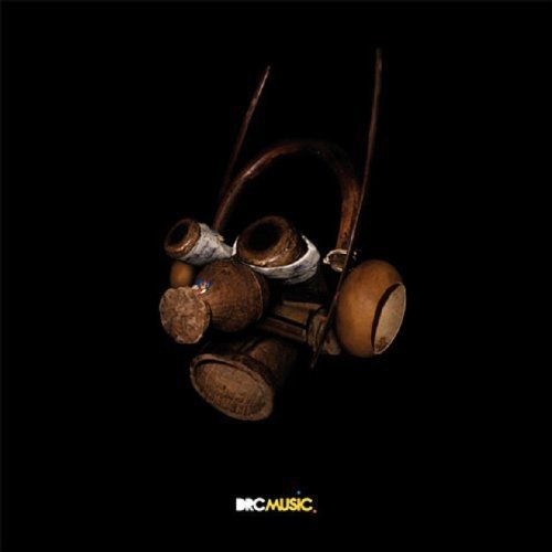 Dark image of traditional African drums against a black background.