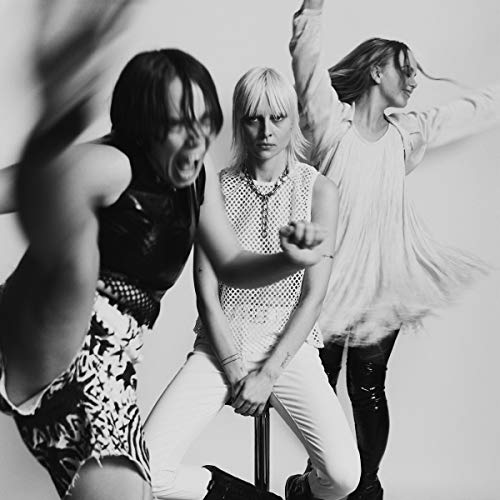 Black and white photo of three people in dynamic poses.