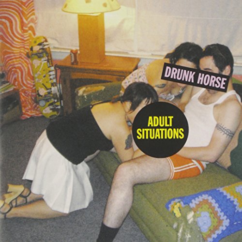 CD cover with two people embracing on a patterned couch.