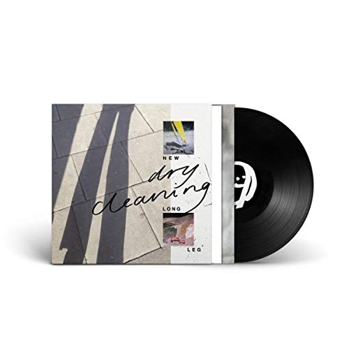 Vinyl record and album cover featuring a shadow on pavement and small photo insets.