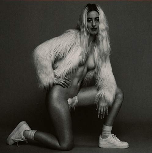 Black and white album cover featuring a kneeling woman in a fur coat.