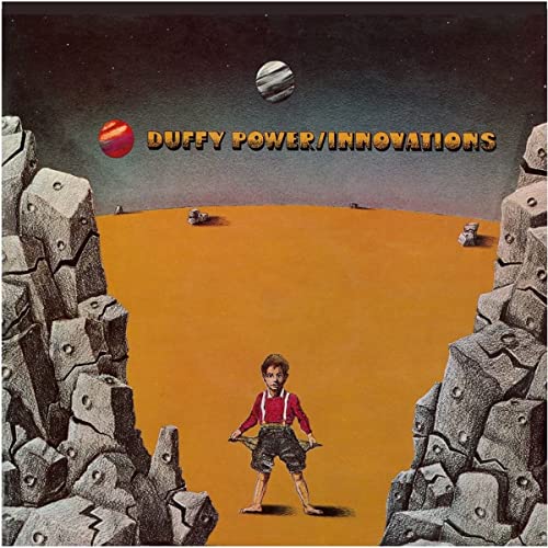 Album cover: boy standing in desert landscape with rocky formations.