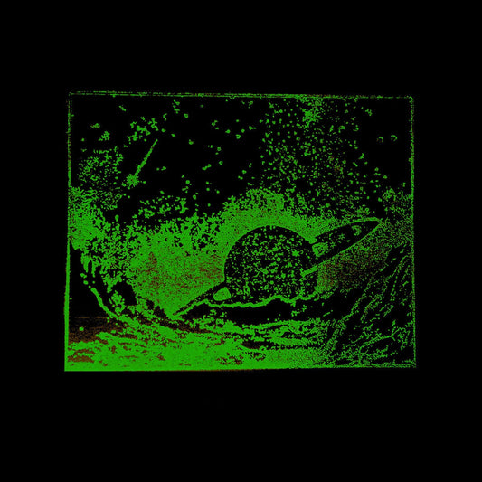 Green, grainy image of a planet with rings emerging from water.