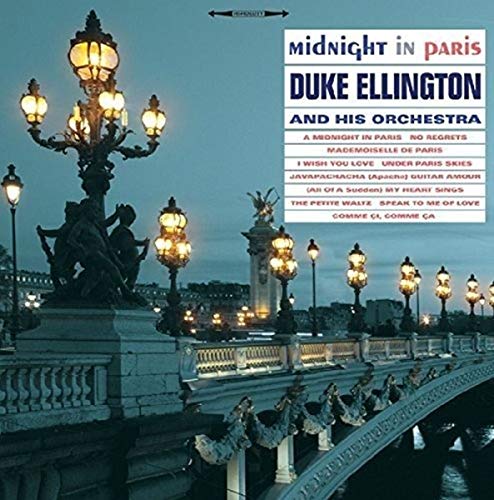 Illuminated street lamps line the Alexander III bridge in Paris at twilight.
