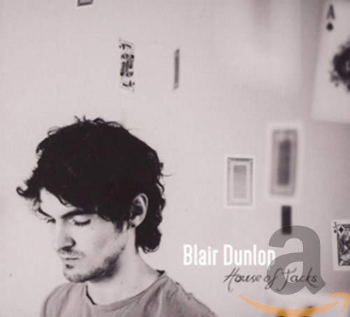 Black and white CD cover featuring a man’s profile and playing cards.