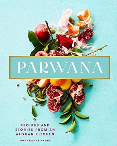 Book cover with pomegranates, citrus, and flowers on a light blue background.
