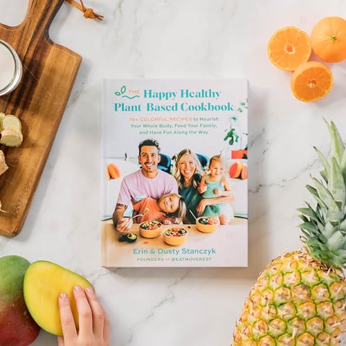 Cookbook cover showing a family eating, surrounded by fresh fruit on a marble surface.