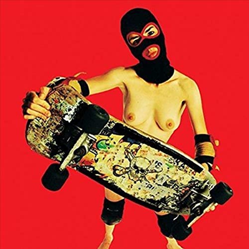 Person in balaclava holding a decorated skateboard against a red background.