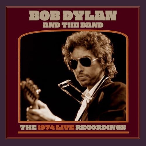 Bob Dylan wearing sunglasses and playing guitar with a harmonica rack, sepia-toned album cover.
