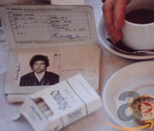 Bob Dylan's "The Bootleg Series 1-3" CD packaging with passport and coffee.
