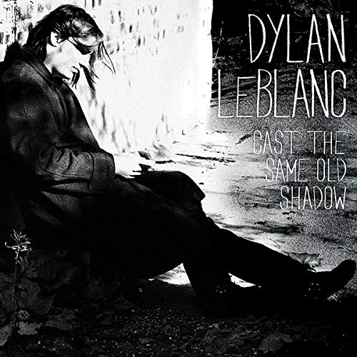 Black and white album cover featuring a seated man and text.