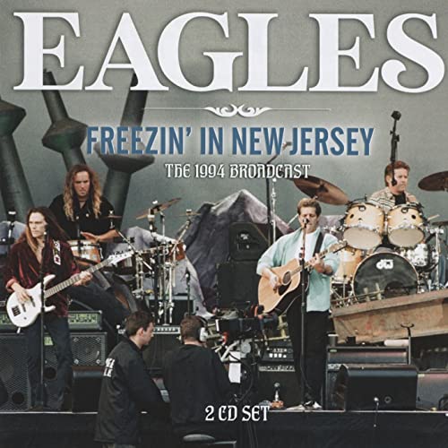 The Eagles band performing live on stage, album cover art.