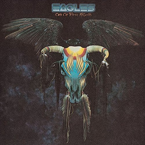 The image depicts the cover of the Eagles' album "One of These Nights". Alt text: Colorful bull skull with wings on a dark background.