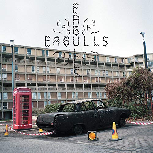 Eagulls album cover: derelict car, brutalist building, and red phone booth.
