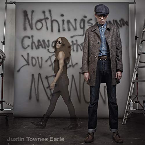 Album cover featuring two people in front of graffiti text.