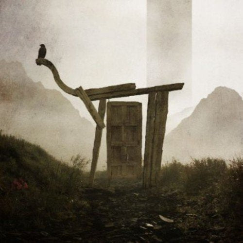 Rustic wooden structure with a crow, misty mountains in background.